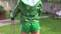 Watching sexy Sandra wearing a sexy green shiny nylon shorts and a green shiny nylon rain jacket enjoying the garden shower (Video)