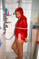 Stella tied and gagged under the shower wearing a shiny red nylon shorts and rain jacket (Pics)