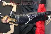 Watching sexy SANDRA wearing sexy black shiny nylon rainwear being tied and gagged overhead with ropes and a ballgag being treated with the massager (Pics)