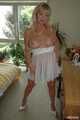 Busty blonde Marlen posing in a white negligee in the bedroom