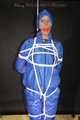 Watching sexy Pia being tied and gagged overhead with ropes and a ballgag wearing a supersexy blue shiny nylon bib overall and a rain jacket (Pics)