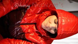 Watching sexy Jill wearing a red shiny nylon rain pants and an oldschool rain jacket under a red downjacket being tied and gagged with ropes and a ballgag on a bed (Pics)