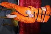 Sexy Pia being tied and gagged with belts a eye patch and a ballgag on a chair wearing a supersexy oldschool orange rainsuit (Pics)