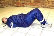 Jill tied and gagged in an old cellar on the floor wearing a shiny blue PVC sauna suit (Pics)