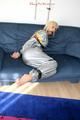 Blond-haired maid tied and gagged with tape wearing a shiny silver PVC sauna suit (Pics)