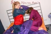 Alina and a friend of her preparing the bed for relaxing and lolling both wearing sexy shiny nylon rainwear (Pics)