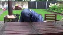 Watching sexy Courtney feeling comfortable in her dark blue  shiny nylon rainwear cleaning the table outside (Video)