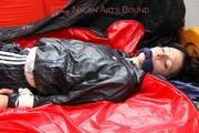 Simone tied and gagged in a big shiny nylon bag to lie in wearing a black shiny nylon shorts and a black shiny nylon rainjacket (Pics)