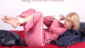 Pia tied and gagged in a beautiful rose shiny nylon rainsuit in bed (Pics)