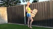 Sexy Sonja wearing a lightblue shiny nylon shorts and a yellow top enjoying the sun (Video)