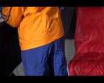 Lucy wearing a sexy blue shiny nylon pants and an orange rain jacket while folding clothes (Video)