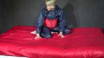 Watching Sonja wearing supersexy red/blue shiny nylon rainwear preparing her bed with shiny nylon cloth (Video)