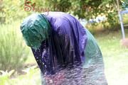 Jill Diamond in the garden playing with water out of the garden hose wearing supersexy shiny nylon rainwear and a rain cape (Pics)