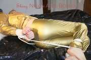 Pia tied, gagged and hooded on bed wearing a sexy golden rain combination and wings (Pics)