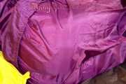 Lucy wearing a supersexy purple rain suit with hood while preparing her bed (Pics)