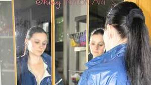 Lucy wearing sexy blue shiny nylon rainwear cleaning the mirror (Pics)