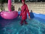 Watch Sandra watering the garden and wetting her shiny nylon oldschool Rainsuit in the Pool