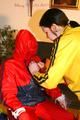 Jill tied, gagged and double hooded on a chair by an archive girl both wearing shiny rainwear (Pics)