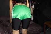 Watching sexy Sandra wearing a sexy black cycling shorts, a top and a sexy green shiny nylon shorts while preparing her bed (Pics)