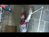 Nicole tied and gagged in a beautiful shiny silver/red PVC suit by Sophie in the cellar (Video)