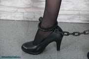 Glamour girl chained and cuffed