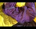 Lucy wearing a purple rain suit preparing her bed cloths for enjoying herself and the rain suit in bed lolling around (Video)