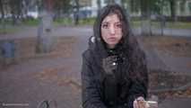 Raven-haired smoker takes a drag on a cork cigarette of her favorite brand