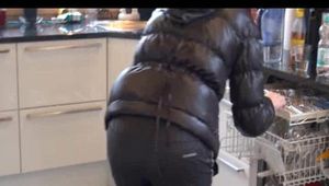 Mara wearing black rainwear tidying up the kitchen (Video)