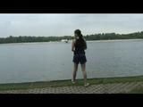 Enni wearing sexy shiny nylon shorts and top while throwing stones in a lake (Video)