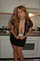 Chubby redhead  Benita stripping out of her black dress in the kitchen