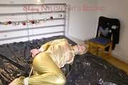 Pia tied, gagged and hooded on bed wearing a sexy golden rain combination and wings (Pics)