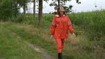 Miss Petra takes a walk in a orange AGU rain suit and rubber boots