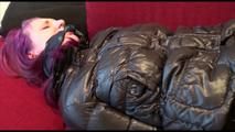 Mara tied and gagged on a sofa wearing a shiny black rain pants and down jacket (Video) 