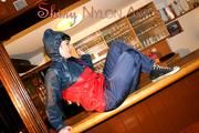 Jill posing and lolling in a bar wearing oldschool shiny nylon rainwear (Pics)