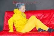 MARA wearing a sexy yellow shiny nylon rain suit lolling and posing on a bed (Pics)