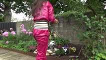 Watching Aiyana wearing supersexy pink shiny nylon rainwear while planting flowers in the garden (Video)