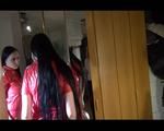 Lucy posing infront of the mirror wearing a supersexy red rainwear jumpsuit (Video)