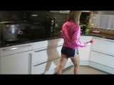 Watching our sexy archive girl wearing a sexy blue shiny nylon shorts and a pink rainjacket doing her housework (Video)