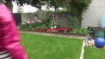 Watching Aiyana wearing supersexy pink shiny nylon rainwear while planting flowers in the garden (Video)