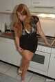 Chubby redhead  Benita stripping out of her black dress in the kitchen