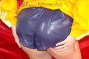 Sonja wearing a sexy blue/purple own designed shiny nylon shorts and a yellow rain jacket posing on the red sofa (Pics)