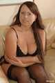 Chubby amateur model Benita posing in bra and stockings on couch