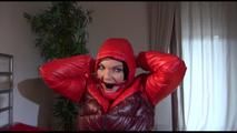 Jill ties, gagges and hoodes herself with cuffs wearing a sexy red shiny nylon down jacket and rain pants (Video)