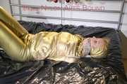 Pia tied, gagged and hooded on bed wearing a sexy golden rain combination and wings (Pics)