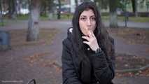 Raven-haired smoker takes a drag on a cork cigarette of her favorite brand