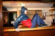 Jill posing and lolling in a bar wearing oldschool shiny nylon rainwear (Pics)
