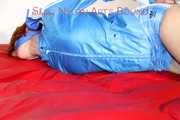 Sonja tied and gagged on bed with ropes wearing a sexy lightblue shiny nylon shorts and a lightblue rain jacket (Pics)