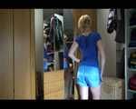Sexy Sojna wearing a jeans and a tshirt trying on several shiny nylon shorts and posing (Video)