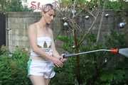 Watching sexy Sonja wearing white shiny nylon shorts and a top during watering the garden (Pisc)