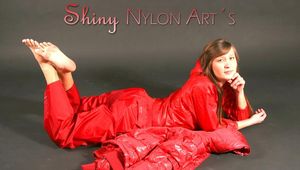Alina posing infront of a camera wearing sexy red shiny nylon rainwear (Pics)